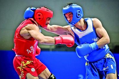 9月28日，杭州亚运会武术项目散打男子70公斤级决赛中，中国选手何烽夺得冠军。图为何烽（右）在比赛中。新华社发