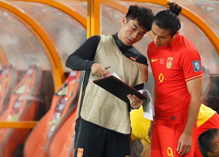 国足助理教师郑智(左)对张玉宁辅导战略。 图/新华社