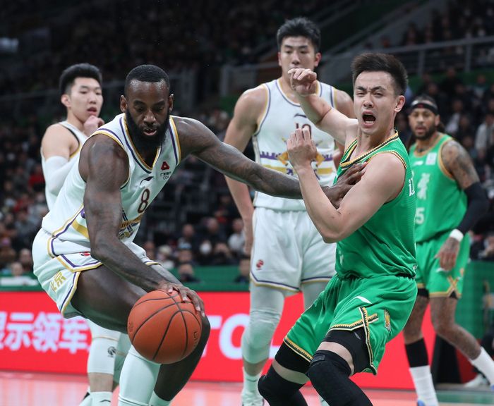 北控队球员桑普森（左）与辽宁本钢队球员赵继伟（右）在比赛中拼抢。  图/新华社