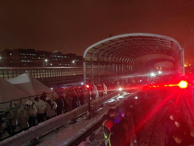 圖為14日西二旗地鐵站臺,乘客冒雪從地鐵軌道上撤離.