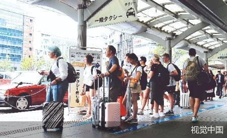 此前，许多人在京都站前排队等候出租车。