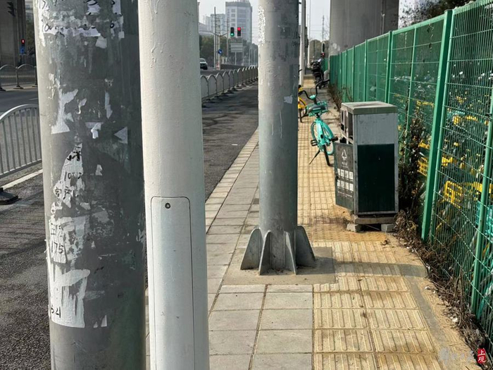 人行道被杆、桩、垃圾箱挤占空间。