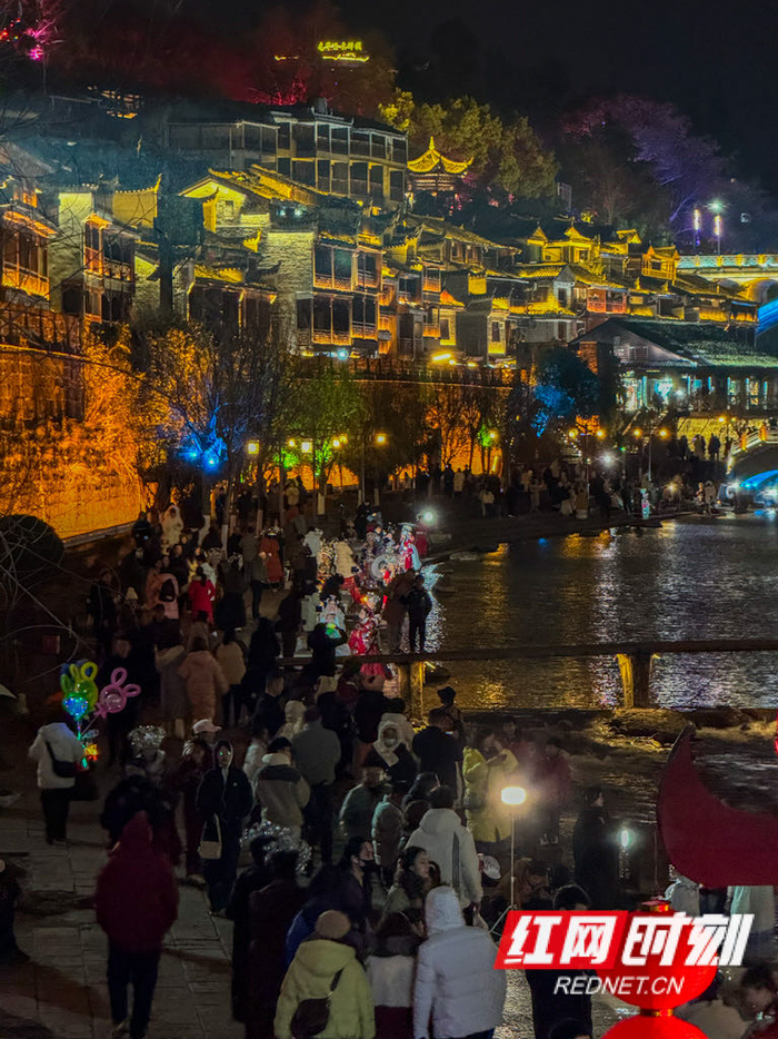 凤凰古城内,来自全国各地的游客夜游沱江,沉醉于边城夜景,古城旅游