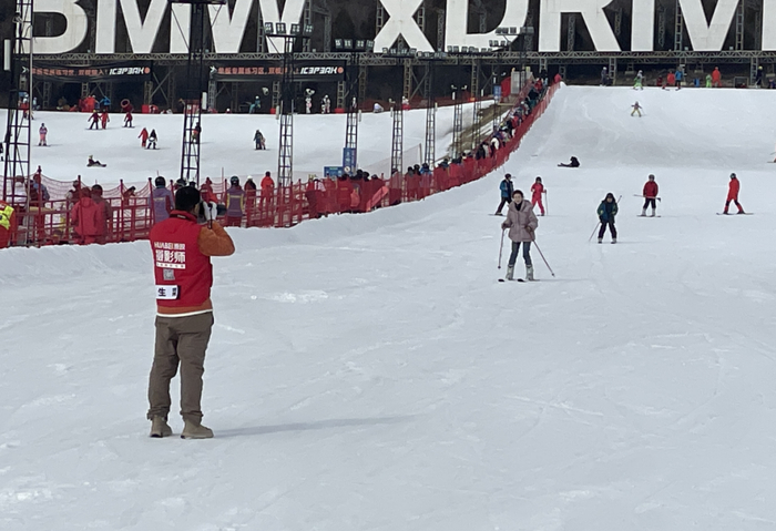 图为“滑呗”摄影师“生菜”在雪场抢拍。