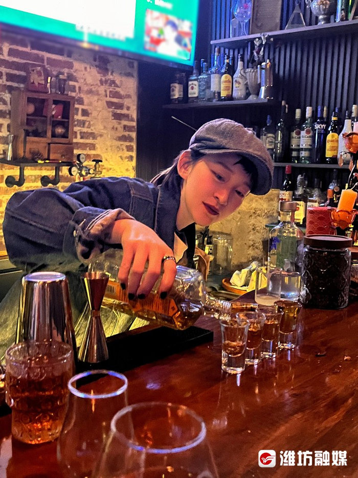 工作中的王君在专业技巧方面,例如花式调酒,男性的力度使得动作更加刚