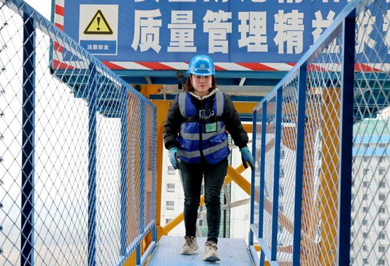 　　李丹行走在塔吊上。吴晗/摄