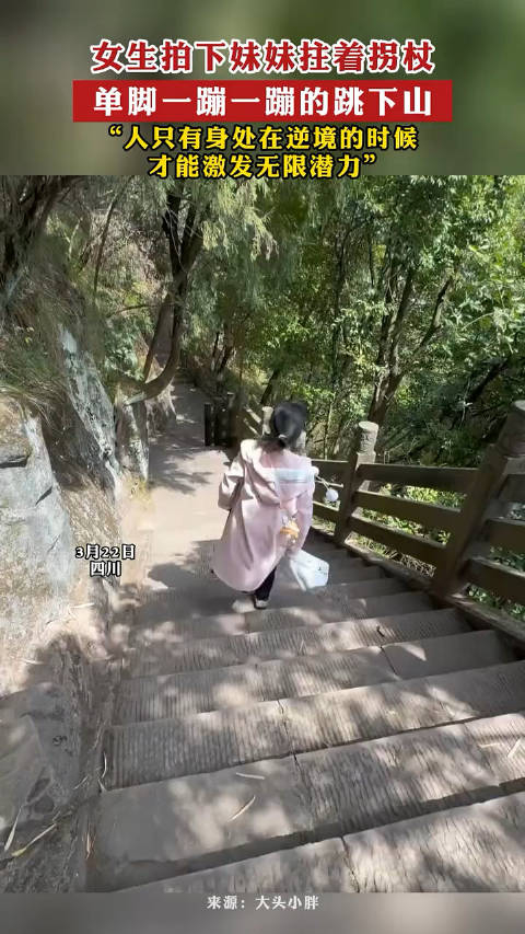 女生拍下妹妹拄着拐杖单脚一蹦一蹦的跳下山