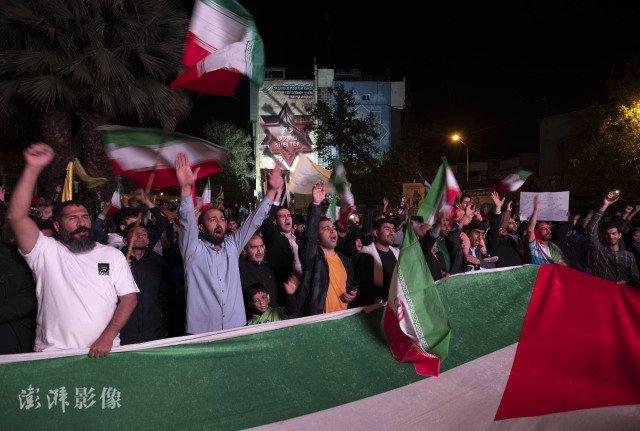 当地时间4月14日，伊朗德黑兰民众在市中心举行集会，支持伊朗军方的行动。图自澎湃影像