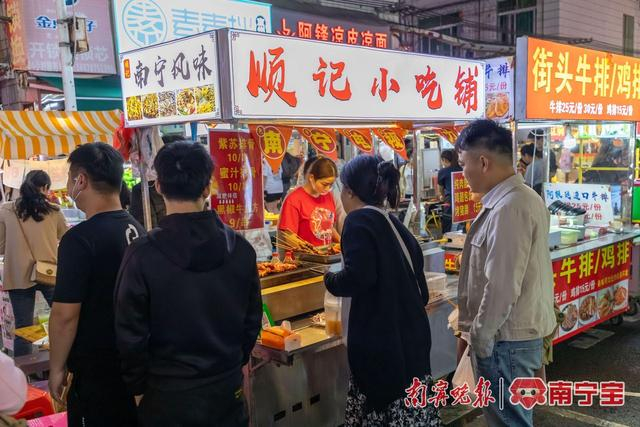 顾客在美食摊前排队购买 通讯员 廖维 摄