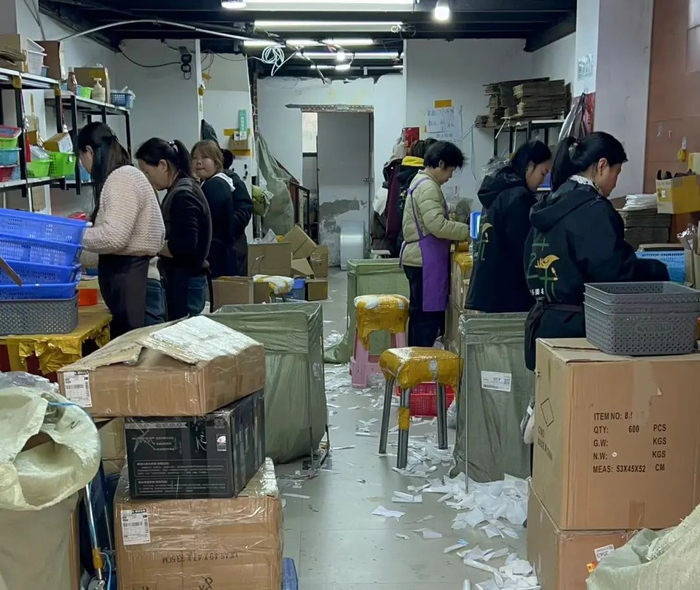 穿戴甲一条街上，负责打包的女性工作人员。（图/时代周报记者王晨婷 摄）