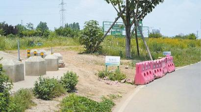 　　一条与天府绿道连接的小路虽设置了路障和提示牌，但电动自行车还是能轻易驶入。