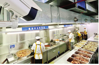 ▲南宁市智兴路初级中学食堂，厨师们在实时监管的摄像头下有条不紊地准备午餐。