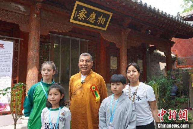 7月13日，河南登封，玻利维亚前外交部长费尔南多·瓦纳库尼与子女在少林寺合影。中新社记者 韩章云 摄