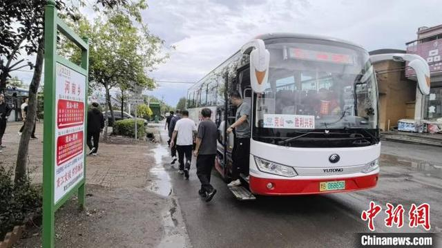 旅客在克山县河南乡乘坐客货邮公交班车出行。 姜辉 摄