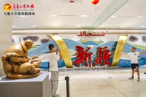 　　在新疆美术馆，观众在“艺汇丝路——西北雕塑艺术巡回展”展馆拍照留念。资料图片