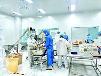 云南罗平鼎泰食品开发有限公司里，工人正在包装干姜片产品。光明日报记者徐鑫雨摄/光明图片