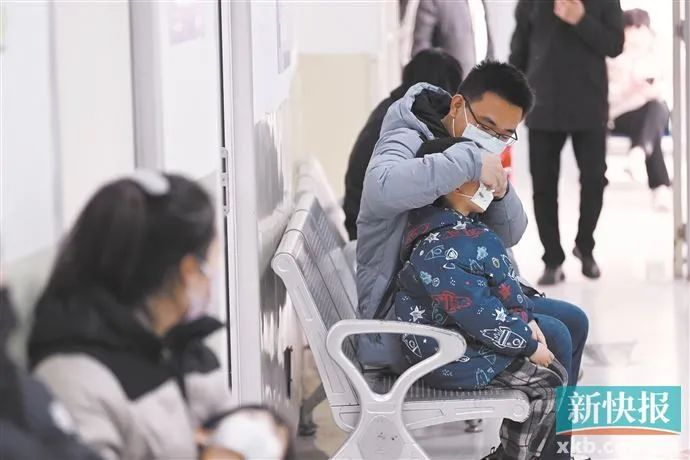 ▲一名家长带着患儿在儿科诊区候诊。（资料图）