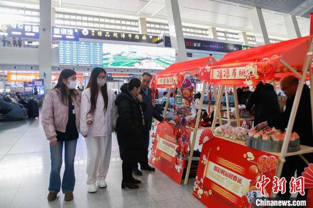 1月14日，西宁火车站，旅客在候车大厅逛非遗集市。中新社记者 马铭言 摄 