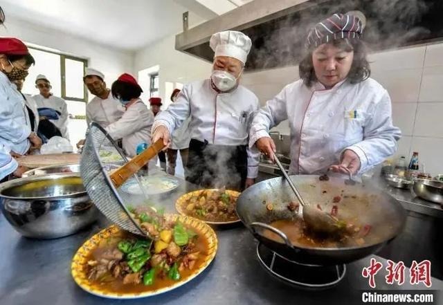 乌鲁木齐市“农家乐”大厨将刚刚烹制好的大盘鸡装盘。刘新 摄