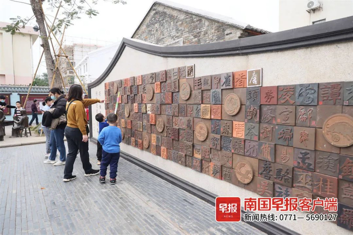 资料图：游客在状元墙前寻找自家姓氏。广西云-南国早报记者 邹财麟 摄