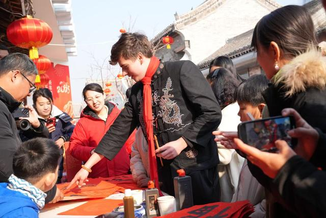 德国博主“包子”根据山里各庄的村民用毛笔写春联。 澎湃新闻记者 王珏玮 图