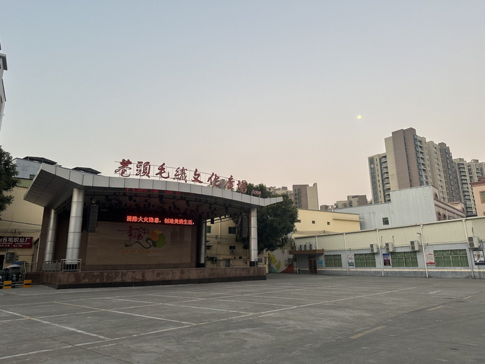 车队的集合地点在巷头毛织文化广场，附近都是从事毛织行业的商铺。