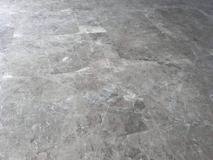 ▲业主阿海表示，小区的装修质量令人担忧，地砖大面积开裂，装修标准与合同承诺的1万元/平方米严重不符