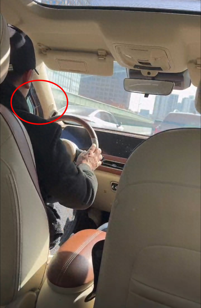 王女士（化名）拍摄的视频显示，司机在行驶过程中有抽烟行为。来源：视频截图