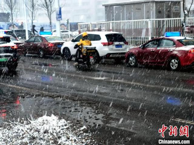 图为外卖小哥冒风雪送餐。中新社记者 王小军 摄