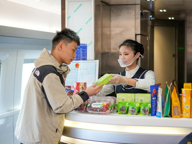 旅客在高铁列车餐车购买青团。 李维莉 图