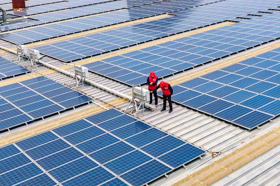 国网高邑县供电公司工作人员帮助企业用户检查屋顶光伏设备。侯旭辰摄