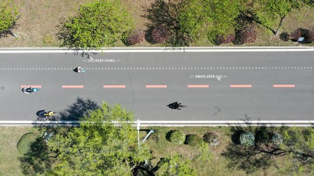 ↑5月2日，市民在长春伊通河滨水绿道上骑车（无人机照片）。新华社记者 张楠 摄 