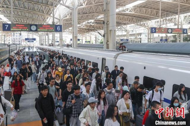 图为5月5日，江西南昌站，旅客从站台上走过。刘力鑫 摄