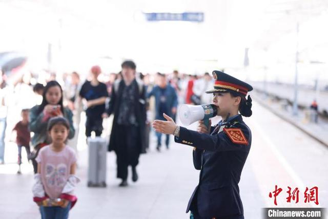 北京北站客运值班员引导旅客出站。记者 贾天勇 摄