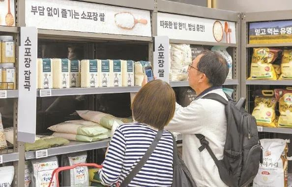 当地时间2025年4月21日，韩国首尔，来自日本的游客在首尔火车站附近的乐天玛特超市查看韩国大米。视觉中国 图