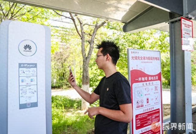 5月29日，在位于益民大厦附近的“城投秒充”光储充全液冷超充站，网约车司机刘伟扫码准备充电。记者米热扎提·木塔力甫摄