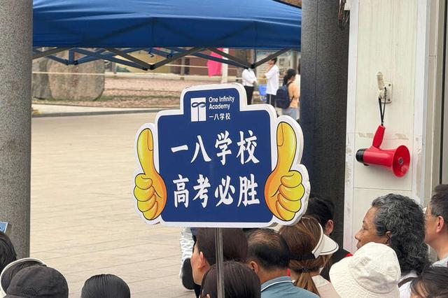 6月7日，河南省实验中学门前，前来送考的老师举着牌子为本校学生送上祝福。中青报·中青网见习记者 李梓昂/摄