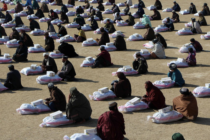 当地时间2025年1月30日，阿富汗坎大哈，阿富汗民众领取由慈善组织发放的冬季援助包。