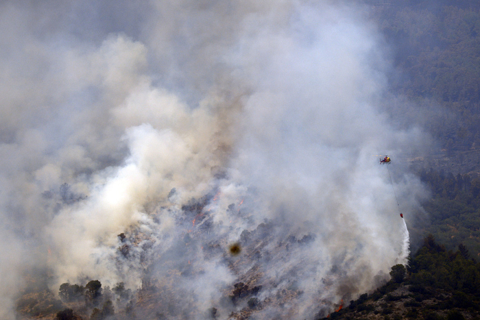 当地时间2025年7月8日，西班牙塔拉戈纳，保尔斯，一架消防直升机在埃尔斯波特自然公园参与森林灭火工作。