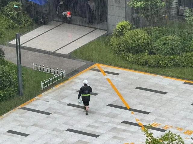 7月12日下午冒雨送外卖的小哥 潮新闻记者 摄 
