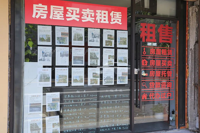 2025年7月15日，上海，房产中介门店，橱窗贴满二手房出售、出租信息。图片来源：视觉中国