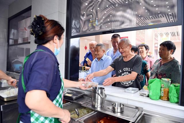 6月22日，老年人在浙江省衢州市常山县球川镇的“幸福食堂”排队取餐。 新华社记者 金良快 摄