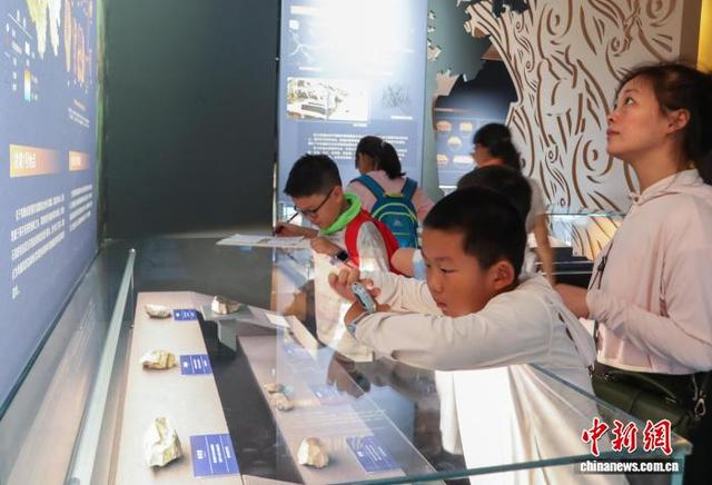 8月3日，青海西宁，学生用儿童手表拍摄展品。中新社记者 马铭言 摄 