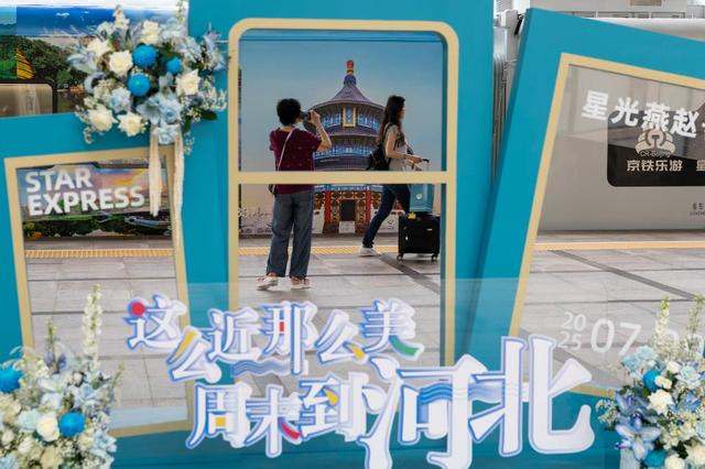 7月9日，在北京站，旅客在“星光·燕赵号”列车旁留影。新华社记者 白雪飞 摄