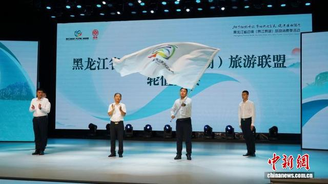 黑龙江省文化和旅游厅将象征联盟轮值主办权的旗帜交予下一届主办方——同江市。虎林市委宣传部供图