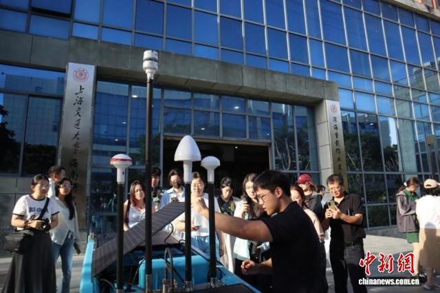 8月22日,上海外国语大学学子走进三亚崖州湾科技城,了解“云帆号”波浪滑翔机的工作原理。马奕 摄