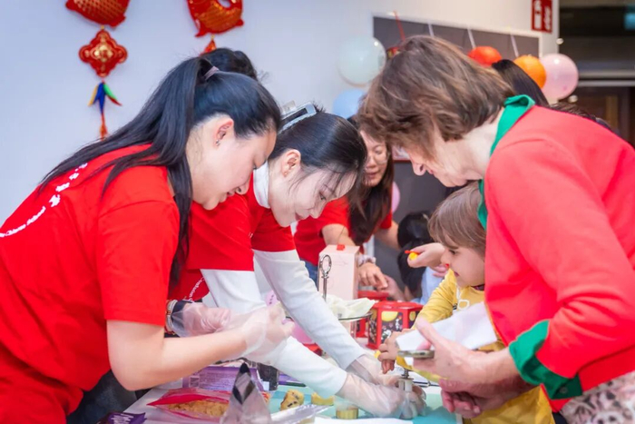 奥地利华人中秋国庆联欢晚会现场，维也纳中文学校孔子课堂的老师们教观众现场制作月饼。受访者供图