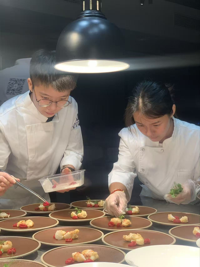  2020年6月，屈雨瑜（左）和娜哥在摆餐。受访者供图