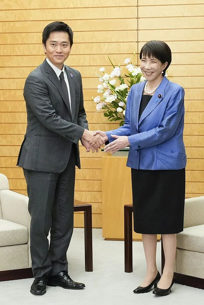 当地时间10月21日，高市早苗（右）与新执政联盟伙伴日本维新会代表吉村洋文在首相官邸握手。图源：视觉中国