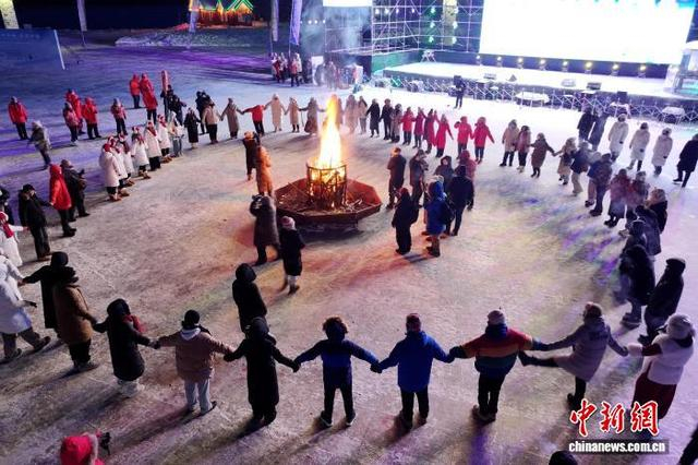 游客和漠河市北极村居民手拉手围着篝火载歌载舞。 邵天李 摄
